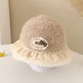 Close-up of children's fleece bucket hat featuring lace trim and checkered bow detail - 52cm / Nice Label Style / Khaki