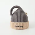 Detailed knit texture of children's two-tone beanie with Ünice embroidery and tail - Gray & Beige
