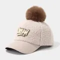 Detail of winter sherpa baseball cap featuring urban patches and brown faux fur pompom - 3-6 Years (50-52cm) / Beige