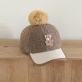 Detailed view of kids baseball cap featuring plush bear embroidery and soft pom pom ball - 50-54cm / Brown