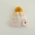 Detail of baby knit hat showing yellow heart patterns and handmade lace patch - Kids 3-8 Years (Elastic) / Yellow Pom Pom