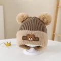 Detail of baby winter hat featuring plush bear ears and warm fleece earflaps - Brown (Style 1)