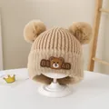 Detail of knit baby bear hat with soft fur trim and pom-poms in warm beige - Style 1 Khaki