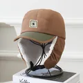 Detail of warm winter trapper hat with thick faux fleece lining and metal G logo patch - Kids 5-12 Years / Coffee