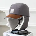 Detail of winter trapper hat showing warm white fleece lining and grey windproof fabric - Kids 5-12 Years / Gray