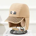 Detail of warm khaki trapper hat with fleece lining and bear patch on a display stand - Kids (5-12 Years) / Khaki