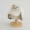 Close-up of beige shearling toddler pilot hat featuring cute puppy patch and ear flaps - Beige