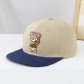 Detail of the 3D brown bear silicone patch with Candy text on a khaki baseball cap - 50-54cm (3-10 Years) / Khaki and Deep Blue