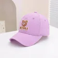 Detail of lavender baseball cap featuring a cute brown bear patch and KIMI embroidery - 50-54cm / Purple