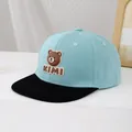 Detail shot of the 3D brown bear silicone patch and KIMI lettering on the baseball cap - 50-54cm (3-10 Years) / Light Blue and Black