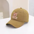 Close-up of yellow cotton baseball cap with 3D teddy bear patch and KIMI lettering - 50-54cm / Brown