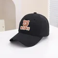 Close-up of black cotton kids baseball cap featuring a cute 3D brown bear and KIMI logo - 50-54cm / Black