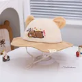 Detailed close-up of corduroy baby bucket hat featuring 3D bear ears and embroidery - Khaki Patchwork Beige