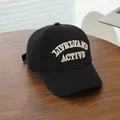Black cotton baseball cap with white Livelyand Active embroidery on a wooden table - Children (3-8 Years Old) / Black