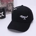 Detailed white dinosaur skeleton embroidery on a black cotton baseball cap for kids - Kids Size / Black