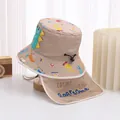 Detail of khaki kids sun hat featuring cartoon dinosaurs and protective neck flap - 48-50cm / Khaki