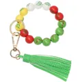 Close-up of Christmas reindeer pattern on colorful wooden beads with green leather tassel - Green