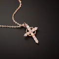 Macro shot of rose gold cross pendant necklace inlaid with sparkling cubic zirconia stones - Necklace / Rose Gold
