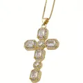 Detailed close-up of gold cross pendant with rectangular and round clear zircon stones - White