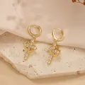 Gold crown cross earrings with sparkling zircons displayed on a textured stone surface - Earrings / Gold