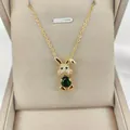 Detail of 14K gold plated rabbit pendant featuring a large green stone and micro-pave crystals - Green