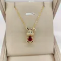 Detailed close-up of 14K gold plated rabbit pendant with pink zircon and white crystals - Dark Red