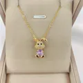 Detailed close-up of 14K gold plated rabbit pendant with pink zircon in a beige jewelry box - Purple
