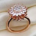 Macro detail of rotating sunflower ring with rose gold petals and zircon inlay - Rose Gold