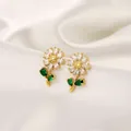 Detail of daisy stud earrings with white petals and emerald green leaves on silk - Floral Stud Earrings (E1302)