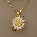 Spinning sunflower pendant necklace in gold with zircon petals on a brown background - Rotatable Sunflower (XL2618)