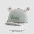 Detailed view of baby smile cap with 3D bear ears and soft green cotton fabric - Baby Size / Pale Green