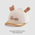 Detail van babypet met zachte klep, 3D pluchen beer en Smile-borduurwerk - Baby Maat / Beige