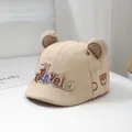 Detail van baby zonnehoed met 3D-belettering en schattige berenoren aan de bovenkant - Peutermaat / Khaki