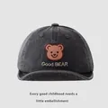 Detailed view of the dark grey bear embroidery and text on a baby sun hat - 45-48cm / Black