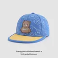 Detail of kids baseball cap featuring blue fabric with bear prints and a yellow flat brim - Adjustable Kids Size / Blue