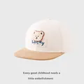 Close-up of a plush bear patch and Lucky embroidery on a kids' flat brim baseball cap - Kids 50-54cm / Off-White Patchwork Khaki