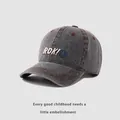 Dark grey washed denim baseball cap with embroidered ROK lettering and smiley face - 50-54cm / Beige
