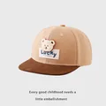 Close-up of a 3D plush bear patch with blue Lucky embroidery on a kids baseball cap - Kids 50-54cm / Beige Patchwork Dark Brown