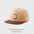 Detalle de gorra infantil con parche de oso Lucky y diseño de visera plana marrón - 50-54cm / Caqui Oscuro