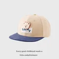 Detailed view of kids lucky bear hip hop cap with beige crown and navy blue flat brim - Kids 50-54cm / Beige/Deep Blue