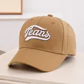 Detailed view of white Jeans 3D embroidery on a khaki cotton baseball cap - Kids 3-10 Years 50-54CM / Coffee