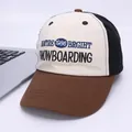 Detail of embroidered snowboarding letters on a tri-color patchwork kids baseball cap - Kids 2-7 Years / Coffee