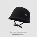 Detail of black cotton canvas kids bucket hat with chin strap and brown cloud leather patch - Black / 48-52cm