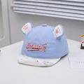 Close-up of light blue baby baseball cap with 3D animal ears and Smiley embroidery detail - 46-48cm / Sky Blue