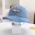 Light blue kids bucket hat with Hello embroidery and white windproof strap on white stand - Baby 2-4 Years / Blue