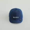 Toddler denim baseball cap in dark blue with white NICE embroidery and a soft brim - NICE Denim Blue
