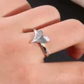 Close-up of heart-shaped copper ring with micro-pave cubic zirconia on model finger - US 7 / Silver