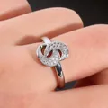 Close-up of interlocking double C ring with micro-paved cubic zirconia on finger - US 7 / Silver