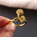 Luxurious gold ginkgo leaf ring with micro-paved cubic zirconia stones held by fingers - US 7 / Gold