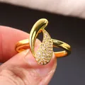 Gold plated ring with abstract curved teardrop design and micro-paved cubic zirconia stones - Size 7 / Gold
